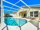 Inviting screened-in pool area with clear blue water and ample seating for relaxation and entertaining at 1049 Winding Water Way, Clermont, FL 34714