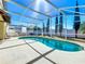 Sparkling pool enclosed with a screen, providing a refreshing escape in a private backyard setting at 1049 Winding Water Way, Clermont, FL 34714