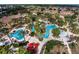Stunning aerial view of resort-style pool, showcasing lush landscaping and amenities for relaxation and entertainment at 122 Capri Dr, Davenport, FL 33897