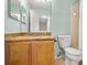 Cozy bathroom featuring a wooden vanity with a granite countertop and light blue walls at 122 Capri Dr, Davenport, FL 33897