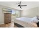Bedroom featuring wood style flooring, ceiling fan, dresser and window view at 122 Capri Dr, Davenport, FL 33897