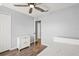 Bedroom with wood floors, white trim, and natural light, creating a serene and inviting space at 122 Capri Dr, Davenport, FL 33897