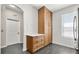 Kitchen featuring hardwood cabinets, white countertops, gray tile flooring, and white door at 122 Capri Dr, Davenport, FL 33897
