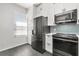 Updated kitchen with stainless steel refrigerator, microwave, oven, and blue honeycomb backsplash at 122 Capri Dr, Davenport, FL 33897