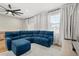 Comfortable living room with blue sectional sofa, white rug, flat screen television, and ceiling fan at 122 Capri Dr, Davenport, FL 33897