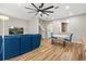 Living room with stairs and hardwood floors, blue sofa, white table, and gray walls at 122 Capri Dr, Davenport, FL 33897