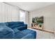 Comfortable living room with blue sectional sofa, white rug, and flat screen television at 122 Capri Dr, Davenport, FL 33897