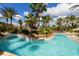 Resort-style lazy river pool surrounded by lush landscaping, creating a tranquil and relaxing atmosphere at 122 Capri Dr, Davenport, FL 33897