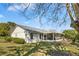 A spacious backyard featuring a screened-in porch, perfect for enjoying the outdoors in comfort at 12235 Warren Rd, Clermont, FL 34711