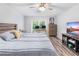 Bedroom featuring wood look flooring, a comfortable bed, and sliding glass doors to the backyard at 12235 Warren Rd, Clermont, FL 34711