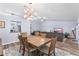 Open-concept dining area with a wood table, stylish light fixture, and easy access to the living room at 12235 Warren Rd, Clermont, FL 34711