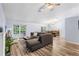 Bright living room featuring a cozy sectional sofa, stylish rug, and natural light from the patio doors at 12235 Warren Rd, Clermont, FL 34711