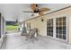 Covered patio featuring comfortable seating and a ceiling fan, perfect for outdoor relaxation at 12235 Warren Rd, Clermont, FL 34711