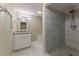 This renovated bathroom offers a tiled shower and granite vanity at 1306 Shepherd Ave, Sanford, FL 32771