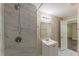 Bathroom featuring a shower with gray and white tiling and a white vanity at 1306 Shepherd Ave, Sanford, FL 32771