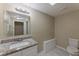 This renovated bathroom offers granite counters, a tile floor, and updated fixtures at 1306 Shepherd Ave, Sanford, FL 32771