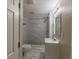 Modern bathroom featuring a shower with gray and white tiling and a white vanity at 1306 Shepherd Ave, Sanford, FL 32771