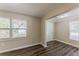 Cozy bedroom with luxury vinyl plank flooring, neutral paint, and two windows at 1306 Shepherd Ave, Sanford, FL 32771