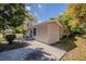 Side view of a freshly painted one story home with a green lawn, a small bush and a driveway at 1306 Shepherd Ave, Sanford, FL 32771