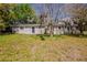 Front exterior view of home with a grassy yard and a tree covered in moss at 1306 Shepherd Ave, Sanford, FL 32771