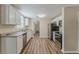 Bright kitchen featuring modern stainless steel appliances, granite countertops and sleek white cabinets at 1306 Shepherd Ave, Sanford, FL 32771