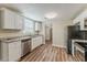 Well-lit kitchen featuring stainless steel appliances, granite countertops, and luxury vinyl plank flooring at 1306 Shepherd Ave, Sanford, FL 32771