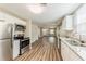 Well-lit kitchen with stainless steel appliances, granite countertop, and open layout to the living area at 1306 Shepherd Ave, Sanford, FL 32771