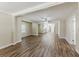 Open-concept living room featuring luxury vinyl plank flooring and views into the kitchen at 1306 Shepherd Ave, Sanford, FL 32771