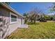 Side yard view with a grassy area and the side of the home, including a door at 1306 Shepherd Ave, Sanford, FL 32771