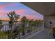 Balcony with views of the lake, pool, and landscaped gardens at sunset at 13427 Blue Heron Beach Dr # 103, Orlando, FL 32821