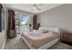 A cozy bedroom with a plush bed, balcony access, and stunning views at 13427 Blue Heron Beach Dr # 103, Orlando, FL 32821