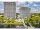 Stunning view of two high-rise buildings and waterfront amenities including a pool and dock with lake access at 13427 Blue Heron Beach Dr # 103, Orlando, FL 32821