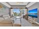 Living room with decorative ceiling, ceiling fan, large format doors to balcony, and flat screen TV at 13427 Blue Heron Beach Dr # 103, Orlando, FL 32821