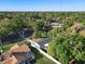 Aerial view shows the home in a lushly landscaped neighborhood at 145 W Fern Dr, Orange City, FL 32763