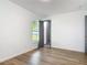 Bedroom with wood-look flooring, window, and ensuite bathroom at 145 W Fern Dr, Orange City, FL 32763