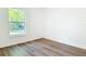 Bedroom with wood-look flooring and window providing natural light at 145 W Fern Dr, Orange City, FL 32763