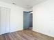 Bedroom featuring wood-look flooring, closet, and modern door at 145 W Fern Dr, Orange City, FL 32763