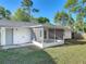 Back exterior view of home with screened in porch and white exterior at 145 W Fern Dr, Orange City, FL 32763