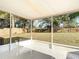 Screened-in porch showcasing tile floor, a covered ceiling, and a view of the backyard at 145 W Fern Dr, Orange City, FL 32763