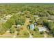 An aerial view displays the property's location with mature trees, lush landscapes and neighborhood at 15765 Sunflower Trl, Orlando, FL 32828