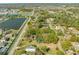 Aerial view of a single-story home with metal roof in a serene neighborhood surrounded by lush greenery and ponds at 15765 Sunflower Trl, Orlando, FL 32828