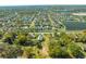 Aerial view of property near a community and lake, featuring mature trees, and lush landscapes at 15765 Sunflower Trl, Orlando, FL 32828