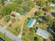 Aerial view of the property showcasing the home, sheds, landscaping, and nearby homes at 15765 Sunflower Trl, Orlando, FL 32828