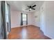 Cozy bedroom with wood floors, a ceiling fan, and a window providing natural light at 15765 Sunflower Trl, Orlando, FL 32828