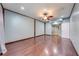 Spacious bedroom with wood-look floors, cool-toned walls, and a ceiling fan at 15765 Sunflower Trl, Orlando, FL 32828