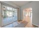 Inviting foyer with wood-look floors, archway, and sliding glass door to the porch at 15765 Sunflower Trl, Orlando, FL 32828