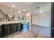 Kitchen and dining area featuring dark cabinets and stainless steel oven range at 15765 Sunflower Trl, Orlando, FL 32828