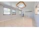 Bright living room with tile floors, multiple windows, and a modern ceiling fixture at 15765 Sunflower Trl, Orlando, FL 32828