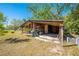 Open storage shed with exposed wood beams and shelving offering ample storage space at 15765 Sunflower Trl, Orlando, FL 32828