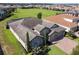 Aerial view of a well-manicured two-story home with stone facade in a lovely neighborhood at 16736 Broadwater Ave, Winter Garden, FL 34787